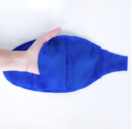 A hand holding a blue donning aid, which is a type of assistive device.